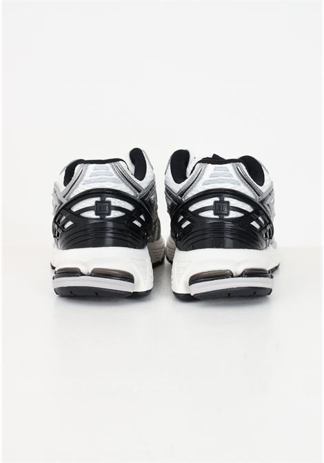 White 1906R sneakers for men and women with metallic silver and black details NEW BALANCE | M1906RER.